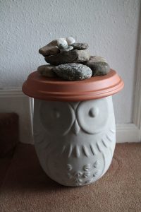 A mini-cairn for Naseeb on an owl-pot in Naseeb's grandparents' hallway